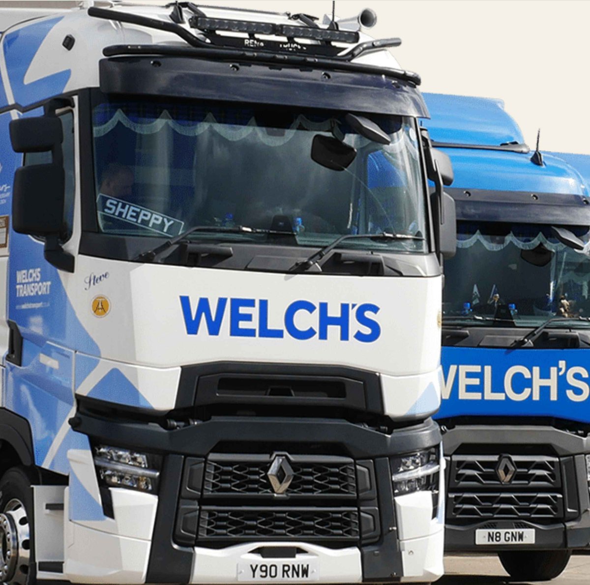 Two Welch's trucks parked side by side